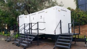 white luxury trailer porta potty in a park